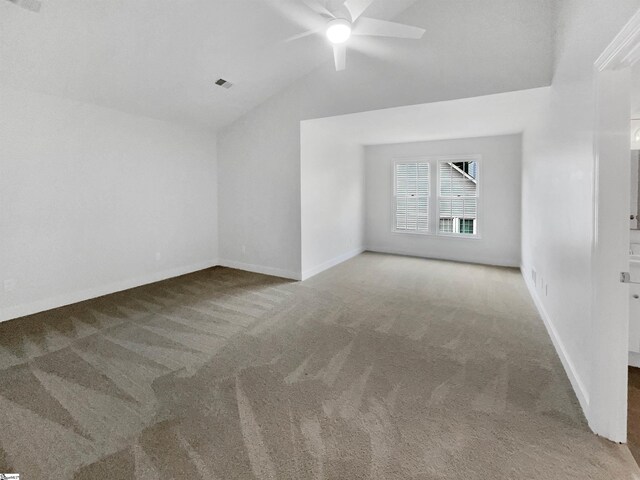 unfurnished room featuring ceiling fan, light colored carpet, and vaulted ceiling