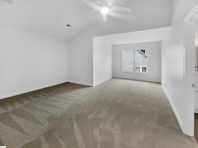 unfurnished room featuring visible vents, lofted ceiling, carpet, and ceiling fan