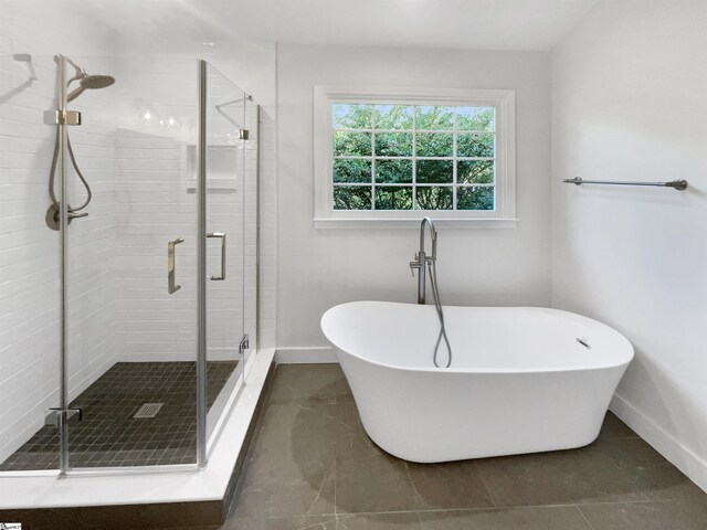 bathroom with independent shower and bath and tile patterned floors