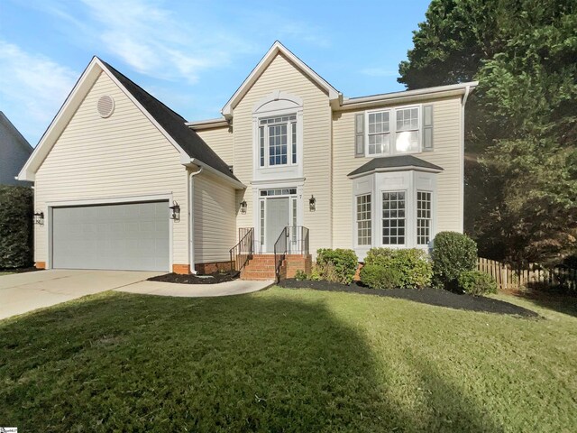 front of property featuring a garage and a front lawn