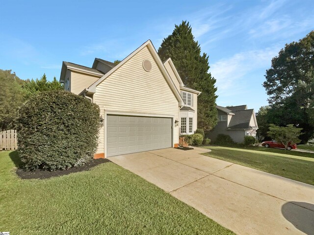 view of front of house with a garage and a front lawn