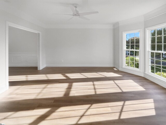 empty room with crown molding, hardwood / wood-style floors, and ceiling fan