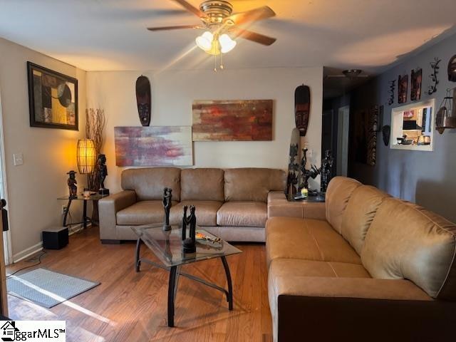 living room with hardwood / wood-style floors and ceiling fan