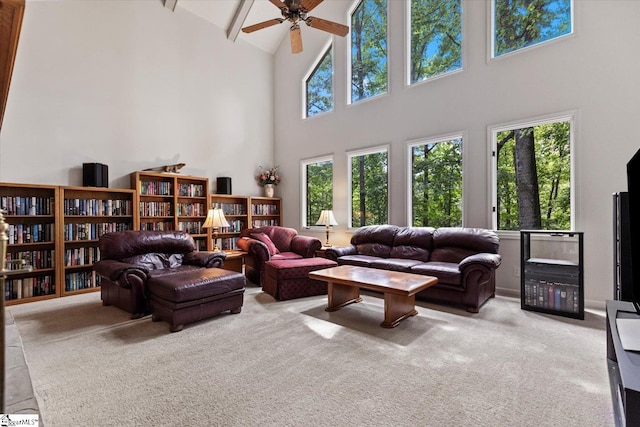 carpeted living room featuring high vaulted ceiling and ceiling fan