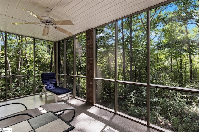 unfurnished sunroom with ceiling fan