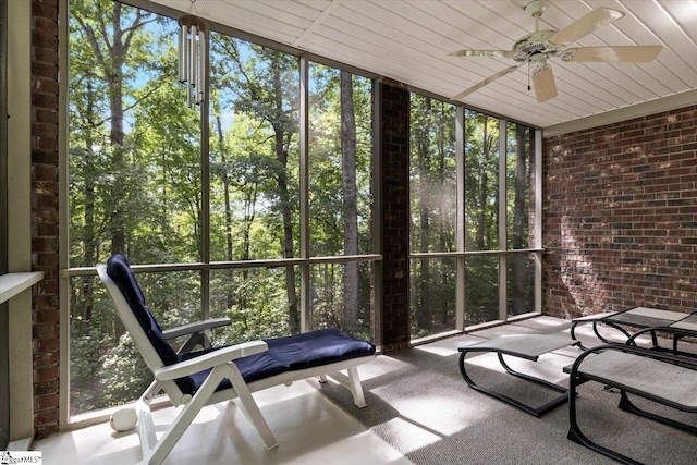 unfurnished sunroom featuring a healthy amount of sunlight and ceiling fan