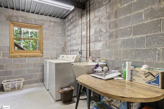 clothes washing area with washer and clothes dryer