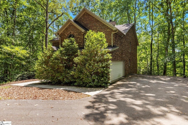 view of side of home featuring a garage