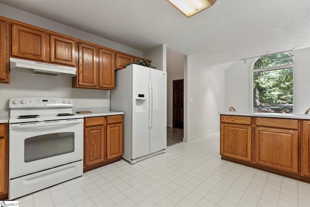 kitchen featuring white appliances and a textured ceiling