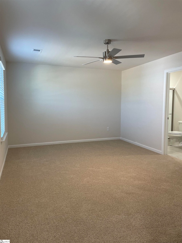 empty room with ceiling fan and carpet floors