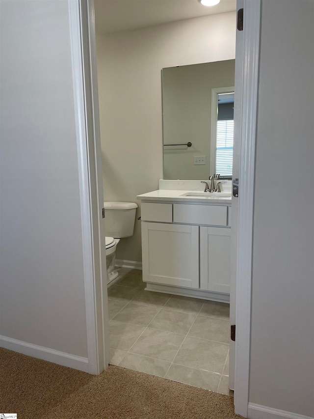 bathroom featuring vanity, toilet, and tile patterned flooring