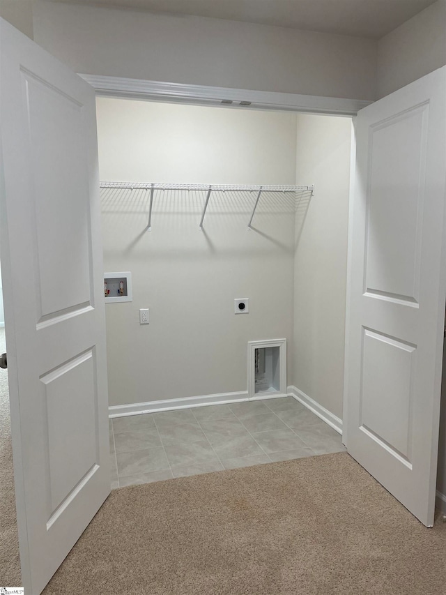 clothes washing area featuring washer hookup, light colored carpet, and electric dryer hookup