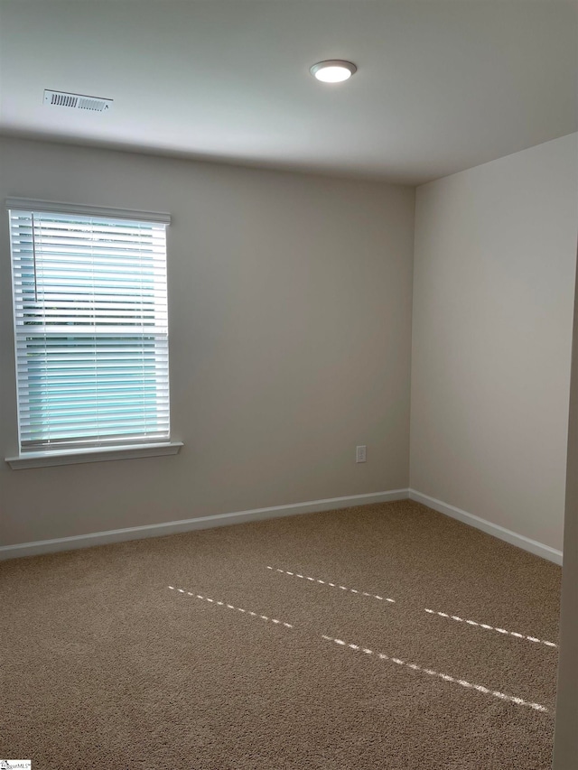 unfurnished room featuring carpet