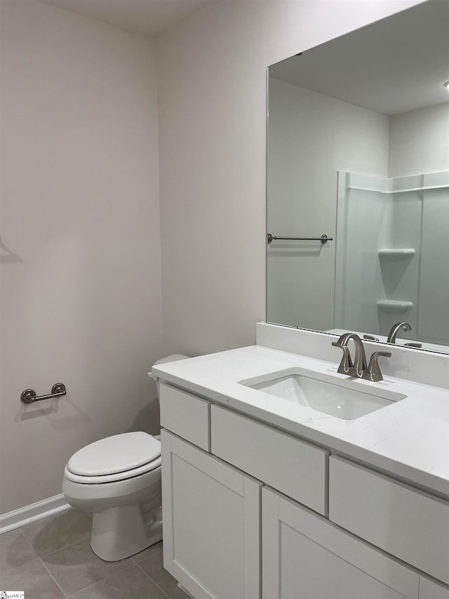 bathroom with vanity, toilet, and tile patterned flooring