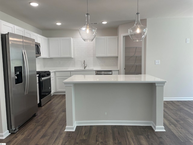 kitchen featuring white cabinets, appliances with stainless steel finishes, sink, and dark wood-type flooring