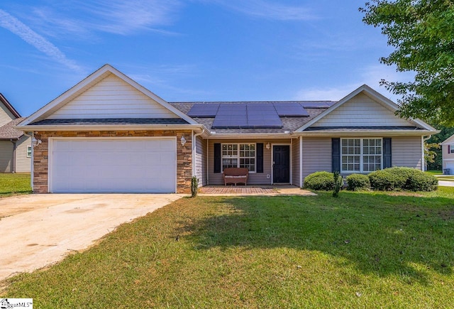 single story home with solar panels, a garage, and a front lawn