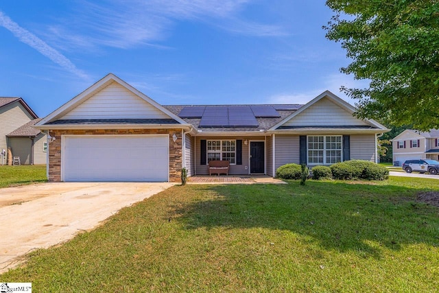 ranch-style house with a garage, a front yard, and solar panels