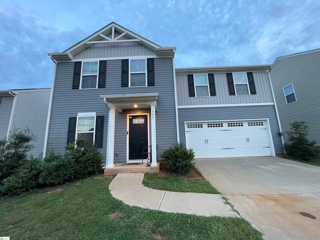 view of front of home with a garage and a front lawn