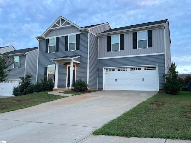 view of front of home with a front lawn and a garage