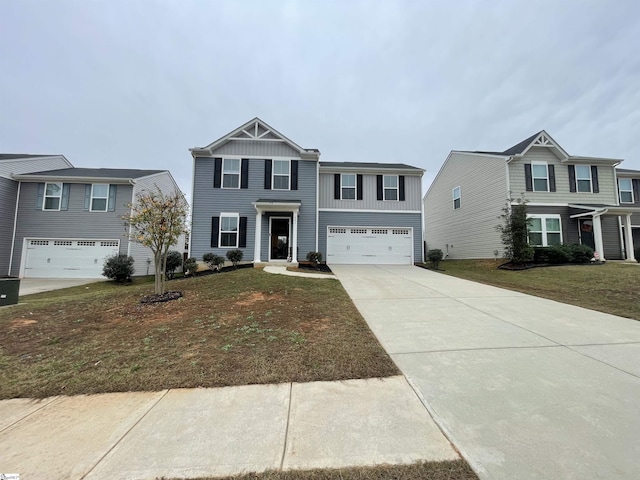 view of front of property featuring concrete driveway, a front lawn, and an attached garage