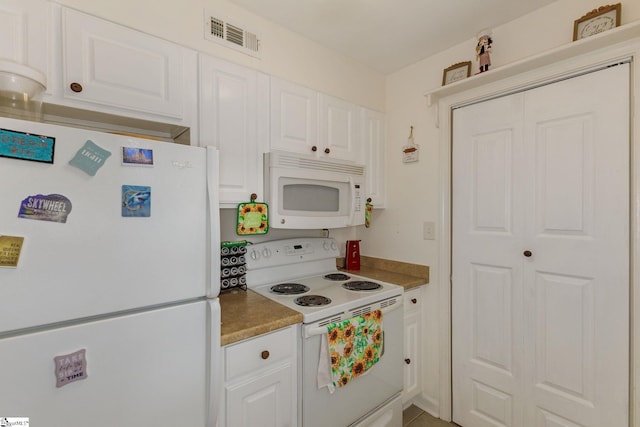 kitchen featuring white appliances and white cabinetry