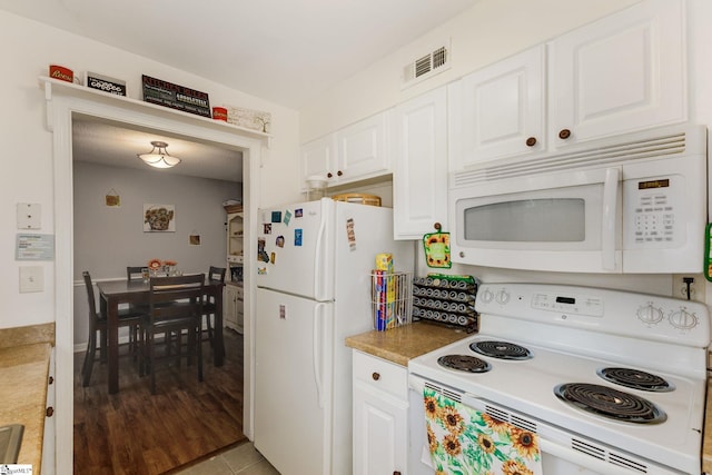 kitchen featuring light wood-type flooring, white appliances, and white cabinets