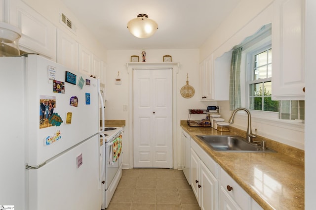 kitchen featuring sink, light tile patterned floors, white appliances, and white cabinetry