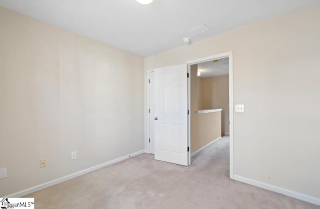 unfurnished bedroom featuring light carpet