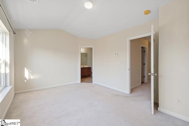 empty room with lofted ceiling and carpet floors