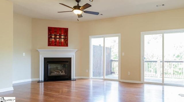 unfurnished living room with hardwood / wood-style flooring and ceiling fan