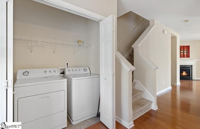 laundry room featuring light hardwood / wood-style floors and washing machine and clothes dryer