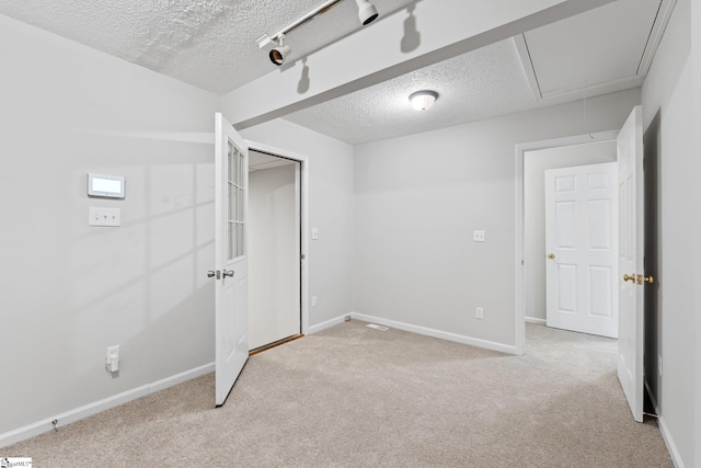 5 Townes Creek Ct, Greenville, SC 29609 - unfurnished bedroom with baseboards, attic access, light carpet, and a textured ceiling
