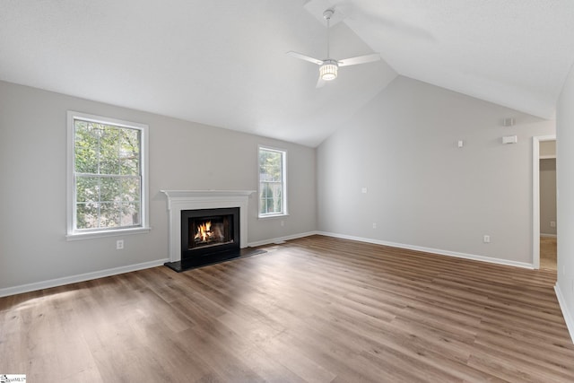 5 Townes Creek Ct, Greenville, SC 29609 - unfurnished living room with vaulted ceiling, wood finished floors, a ceiling fan, and a warm lit fireplace