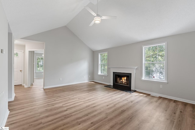 5 Townes Creek Ct, Greenville, SC 29609 - unfurnished living room featuring baseboards, vaulted ceiling, a warm lit fireplace, ceiling fan, and light wood finished floors