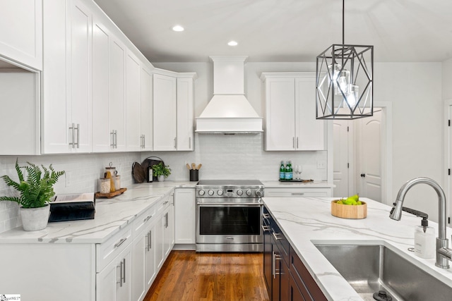 kitchen featuring white cabinets, sink, premium range hood, high end range, and dark hardwood / wood-style floors