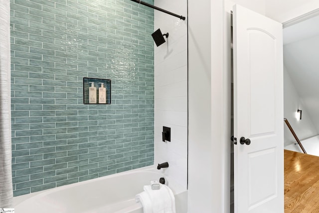 bathroom featuring tiled shower / bath combo and hardwood / wood-style floors