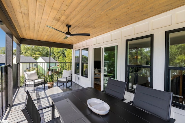 unfurnished sunroom featuring ceiling fan and wooden ceiling