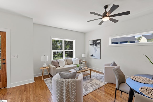 living room with ceiling fan and light hardwood / wood-style floors