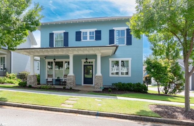 view of front facade with a front lawn and a porch