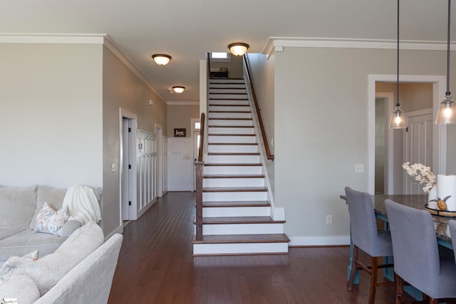 stairway with crown molding and hardwood / wood-style floors