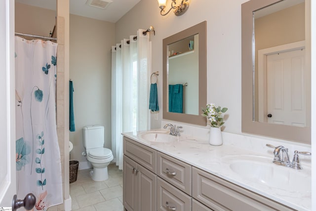 bathroom with a shower with curtain, vanity, tile patterned flooring, and toilet