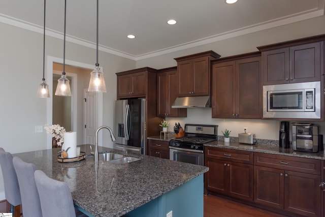 kitchen featuring a center island with sink, appliances with stainless steel finishes, sink, and dark stone counters