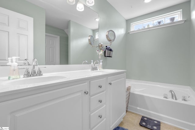 bathroom with vanity, a tub, and tile patterned flooring