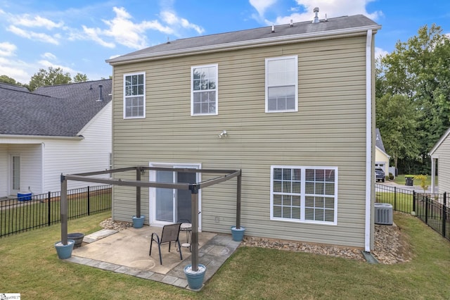 back of house featuring central AC unit, a patio area, and a yard