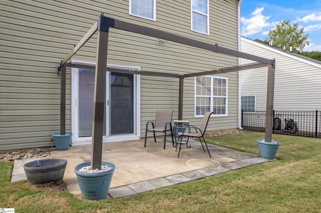 rear view of property with a yard and a patio