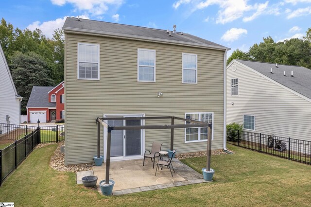 back of house featuring a yard, a garage, and a patio area