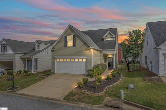 view of front of house featuring a yard and a garage