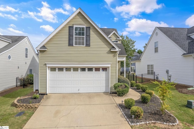 front facade featuring a garage and a front lawn