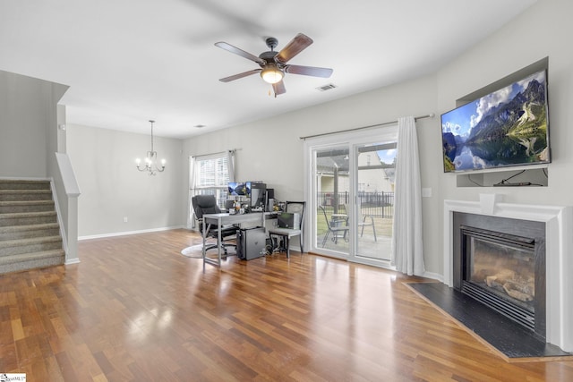 interior space featuring ceiling fan with notable chandelier, hardwood / wood-style flooring, and a wealth of natural light