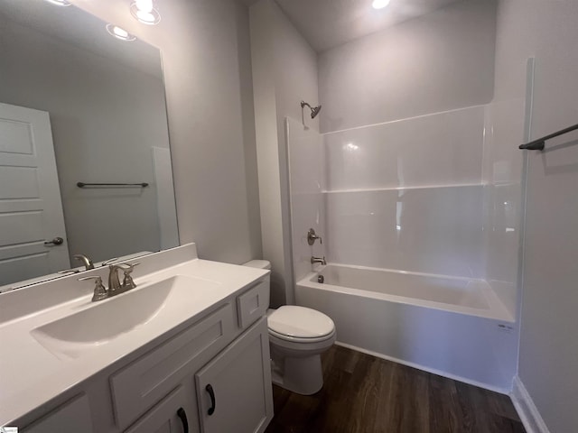 full bath with vanity, bathtub / shower combination, wood finished floors, and toilet